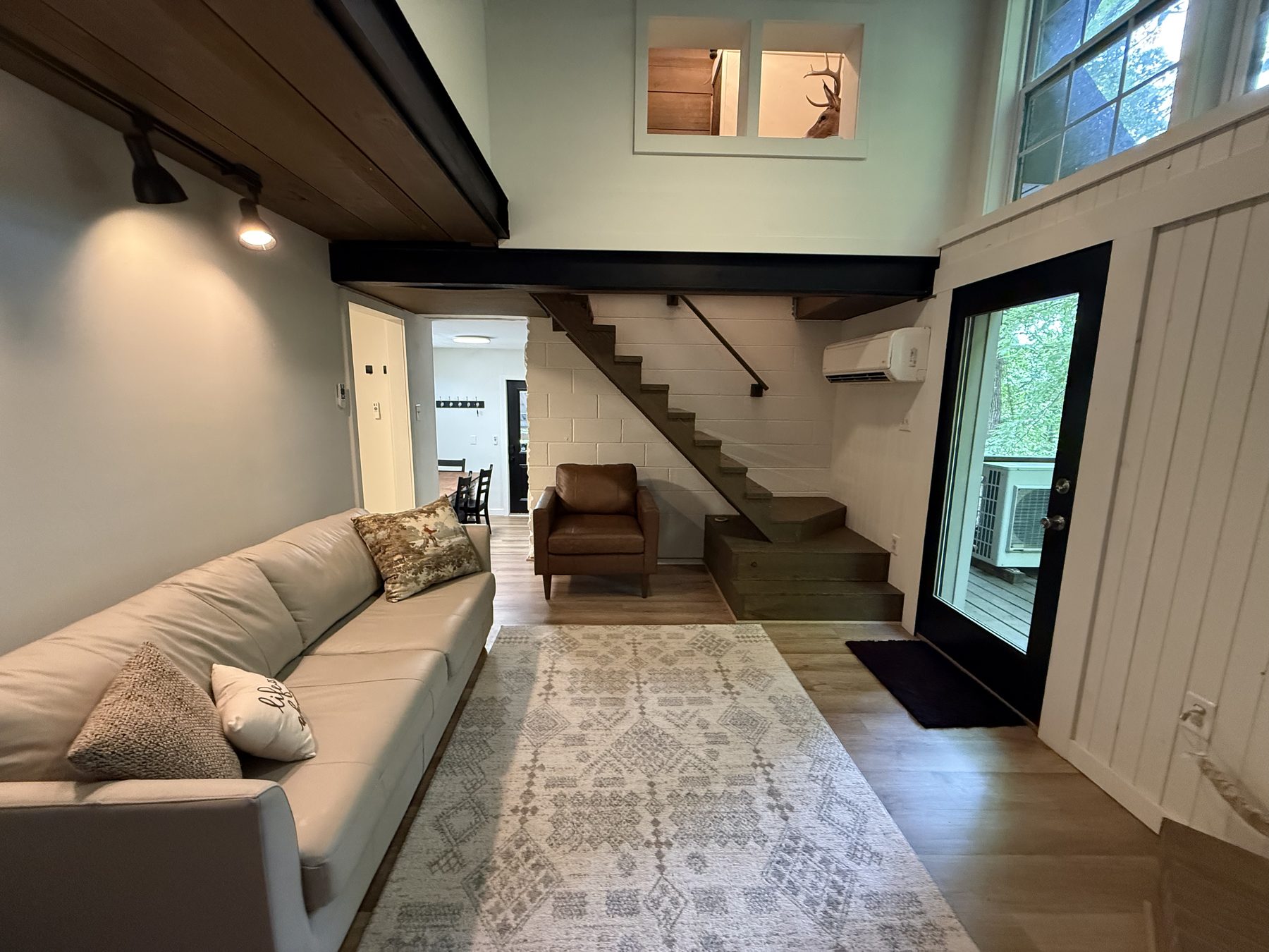 Living room with loft staircase